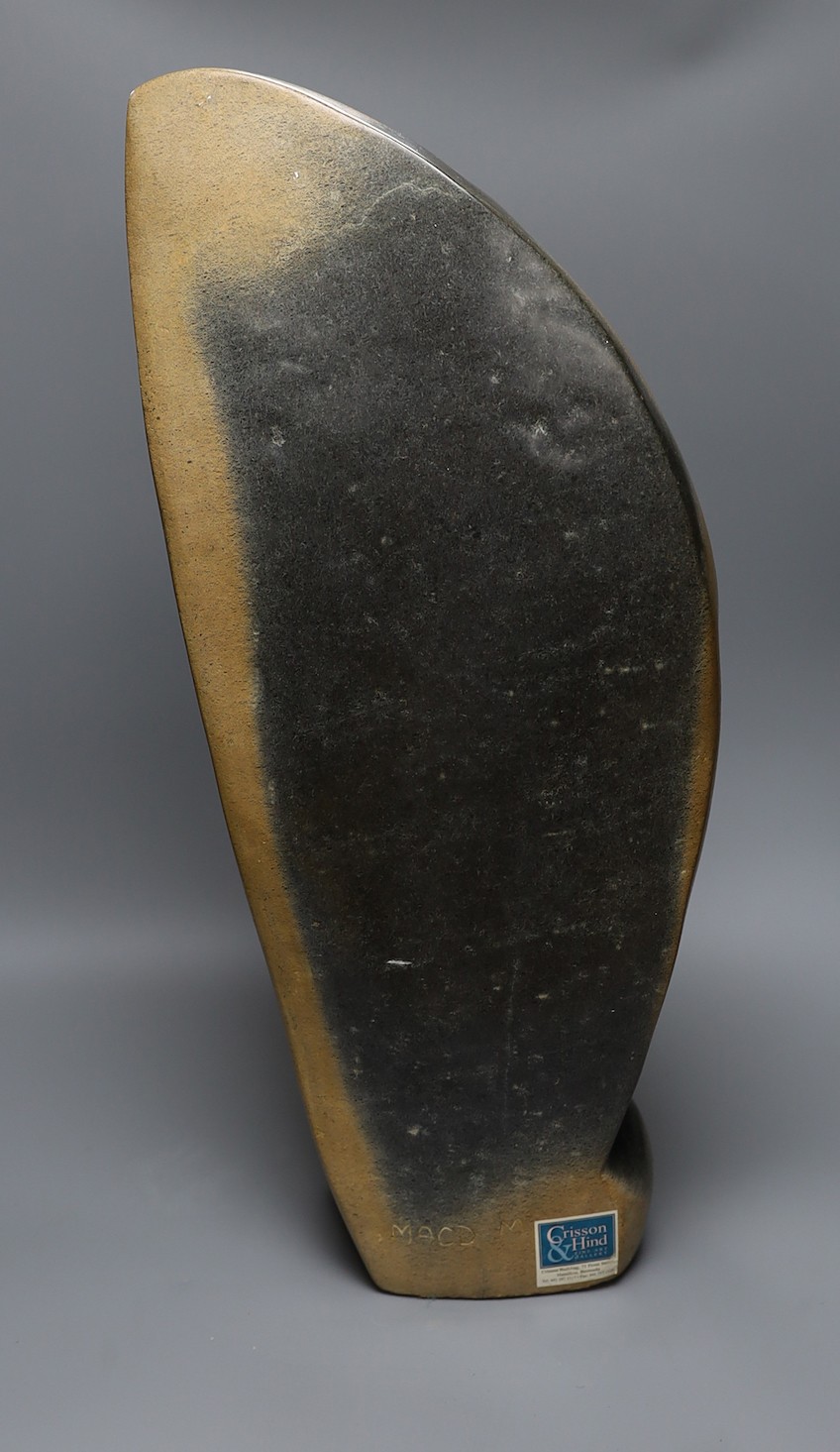 A Zimbabwean carved and polished stone figure of a stylised winged bird, with a long neck. 64cm